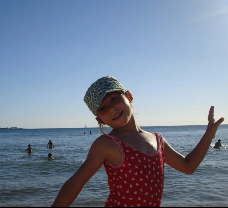 Sofi Lopez at the beach in a red swimsuit