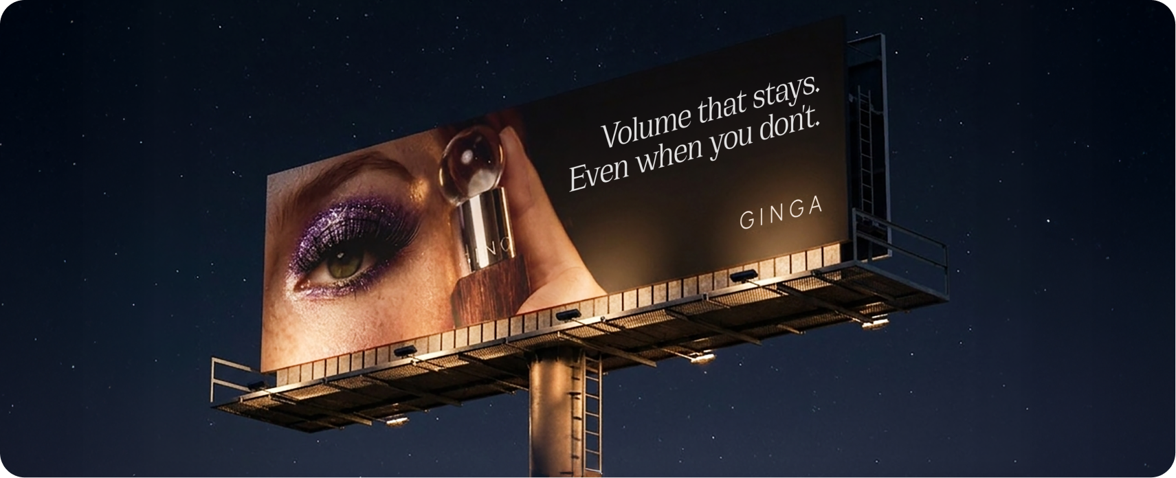 Ginga — nighttime billboard reading 'Volume that stays. Even when you don't.' with a purple glitter eye and mascara wand against a starry sky