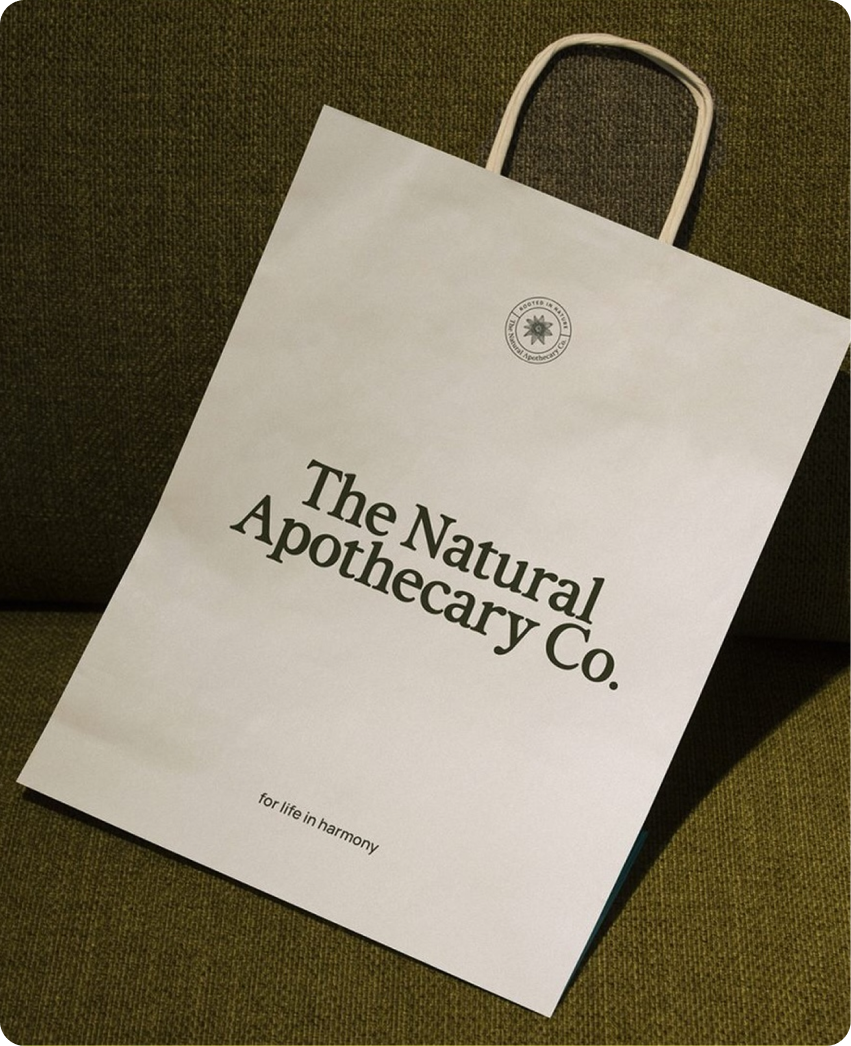 The Natural Apothecary — skincare bottle hero shot in editorial set