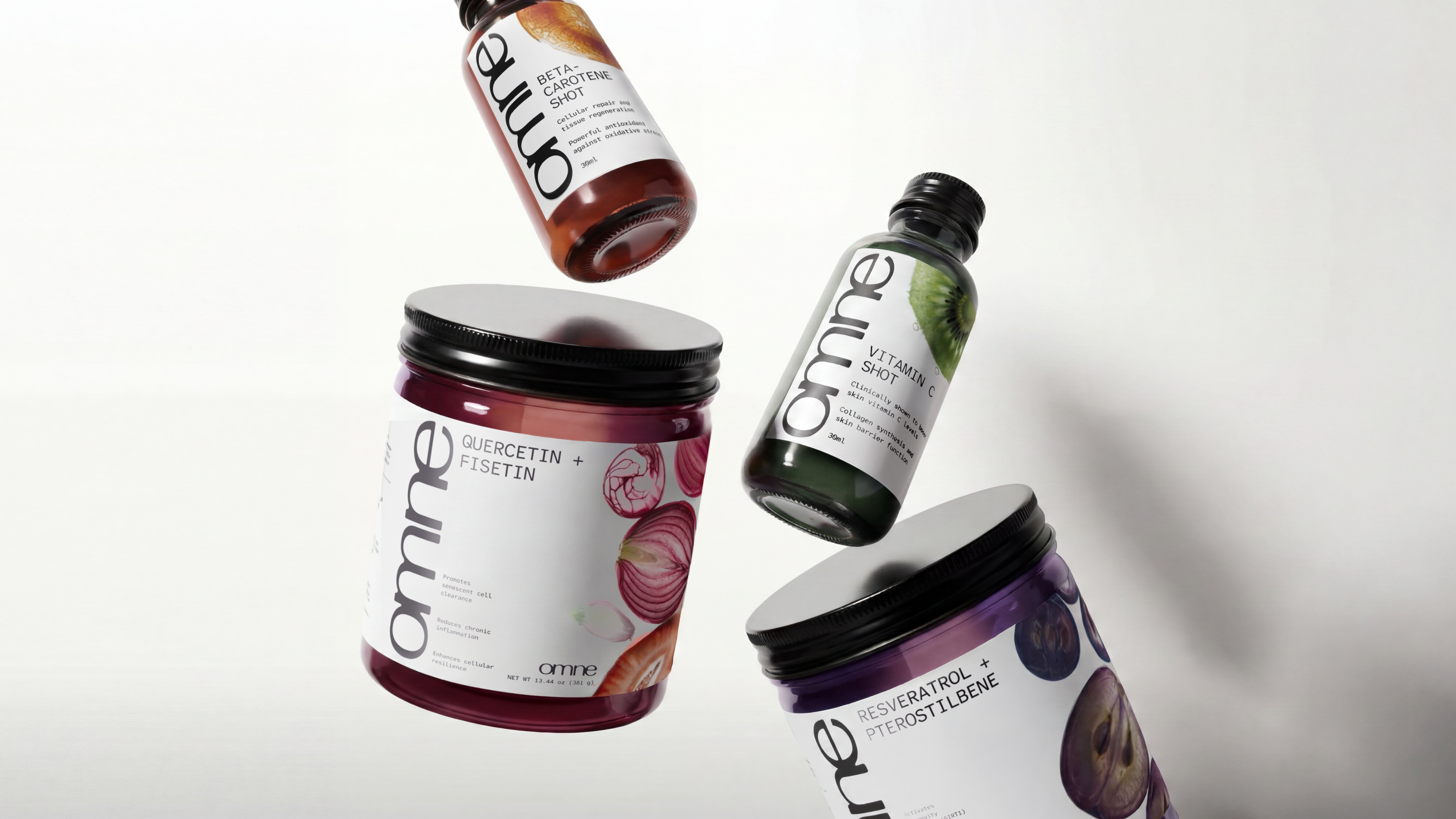 Omne — editorial product shot of multiple jars and shots in motion against a moody backdrop
