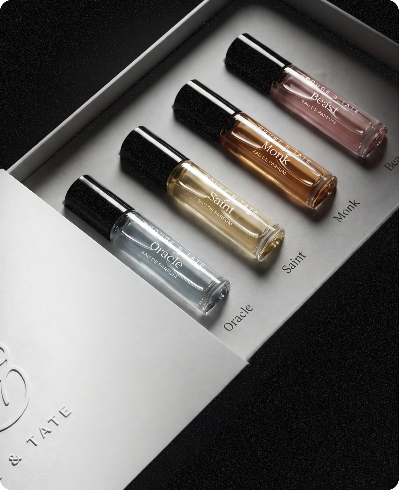 Rouge & Tate — the discovery set: Oracle, Saint, Monk, and Beast in miniature vials, laid inside their embossed cardboard case