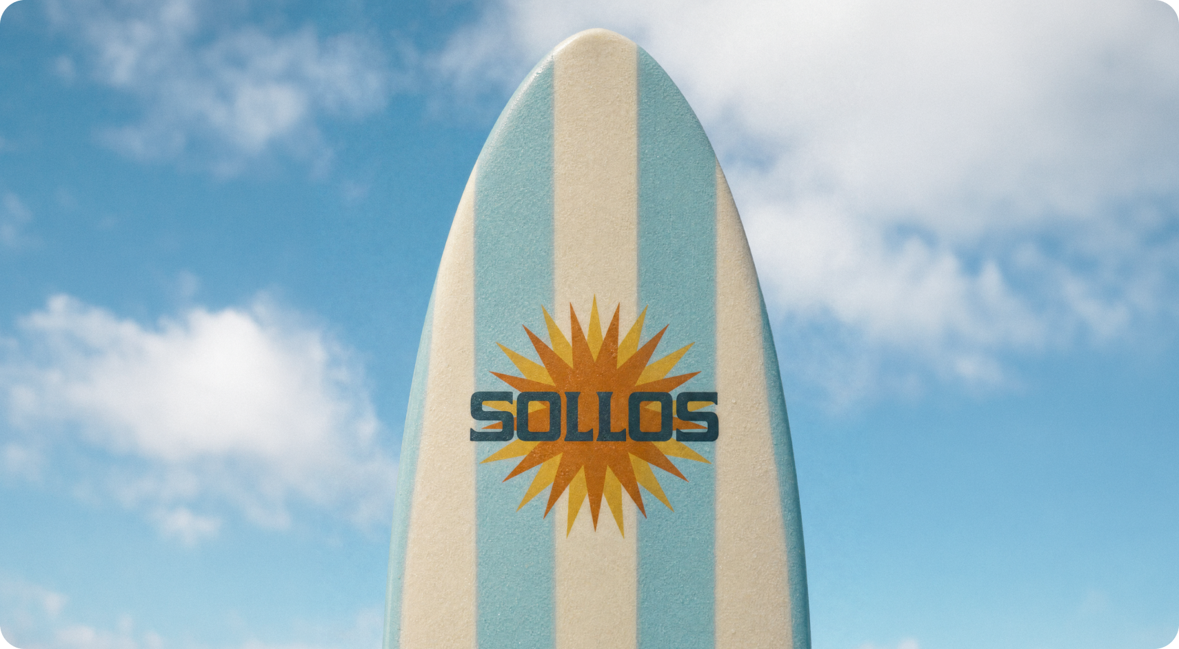 Sollos — a surfboard standing in the sand, cream and sky-blue stripes with the Sollos sunburst mark against a clear blue sky
