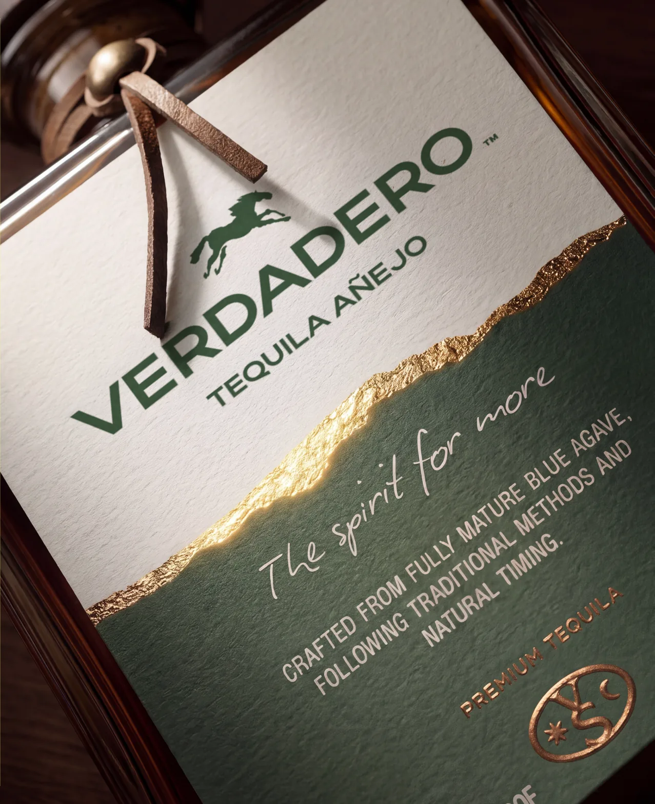 Verdadero — the Tequila Añejo bottle in close-up, gold label against deep green