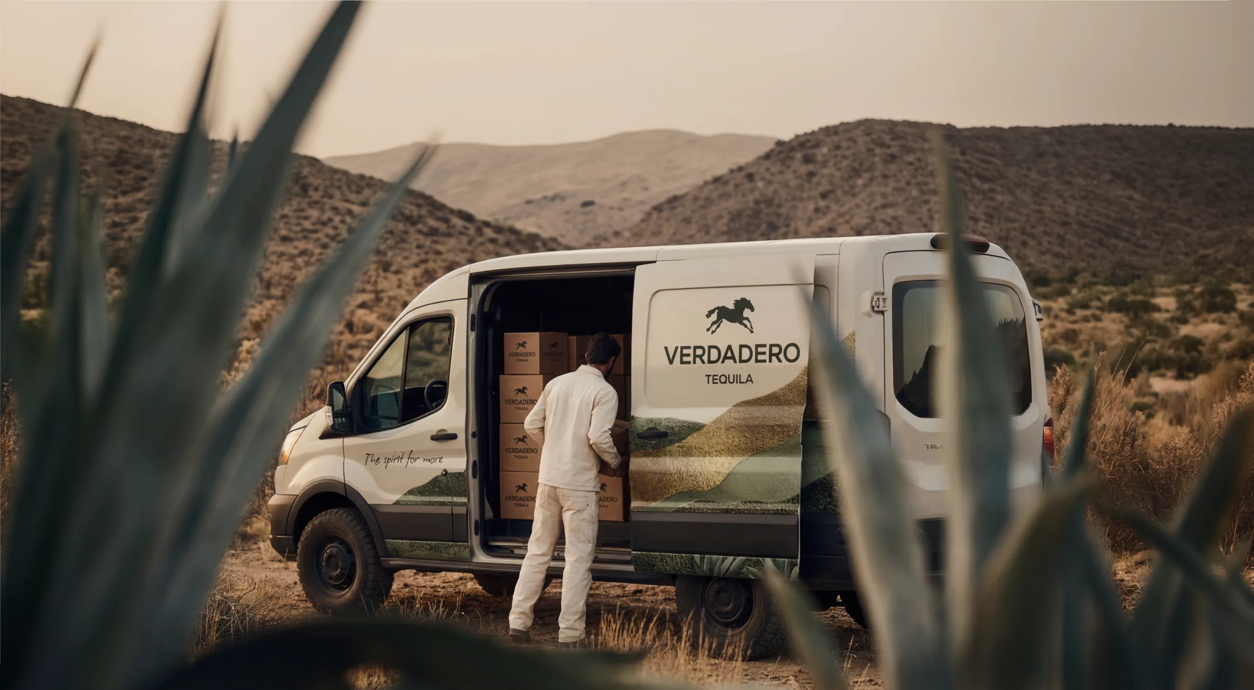 Verdadero — a branded delivery van on a desert road among the agave