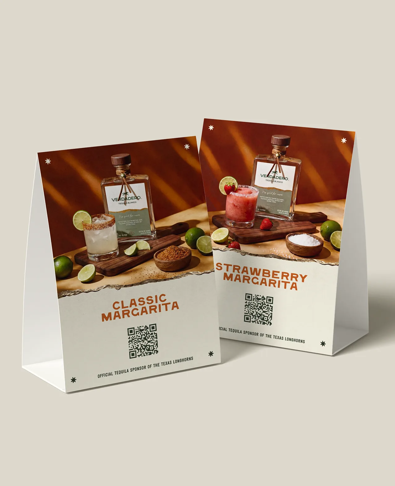Verdadero — bar table-tent cards for the Classic and Strawberry Margarita, each with a serve photo and QR code